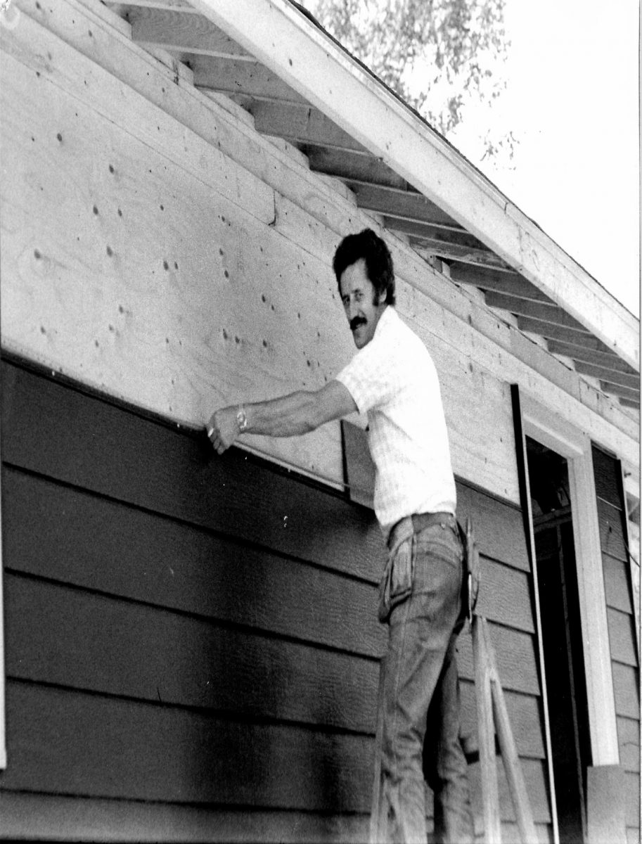 Beaulieu Home Improvement's founder, Phil Beaulieu, installing siding on a house